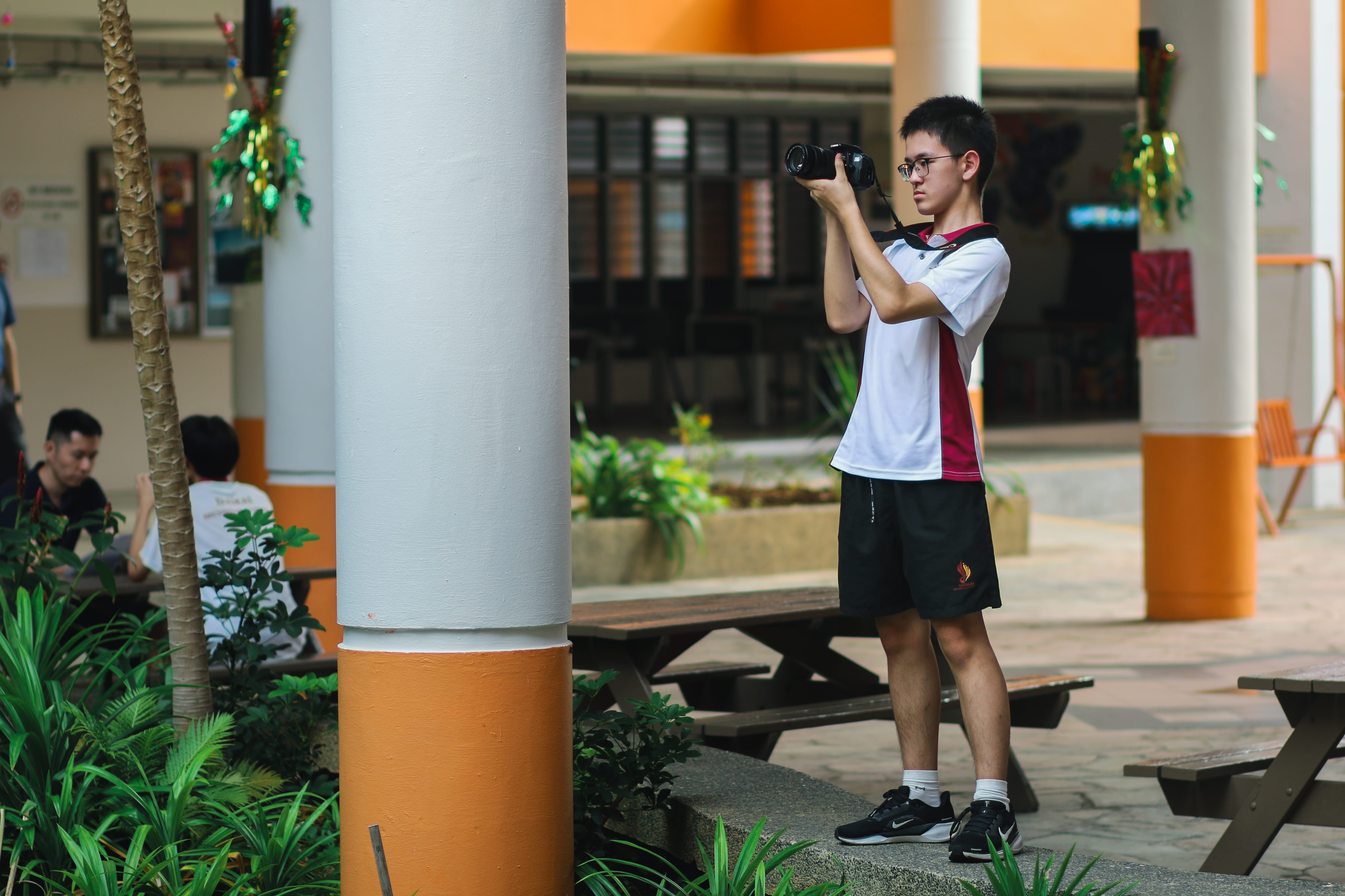 Students engaged in taking photos around the school